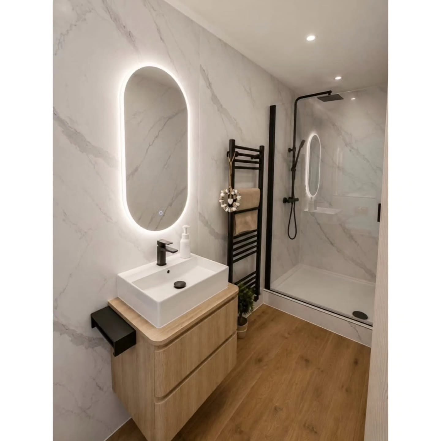 Finished en-suite shower with marble walls and black fittings