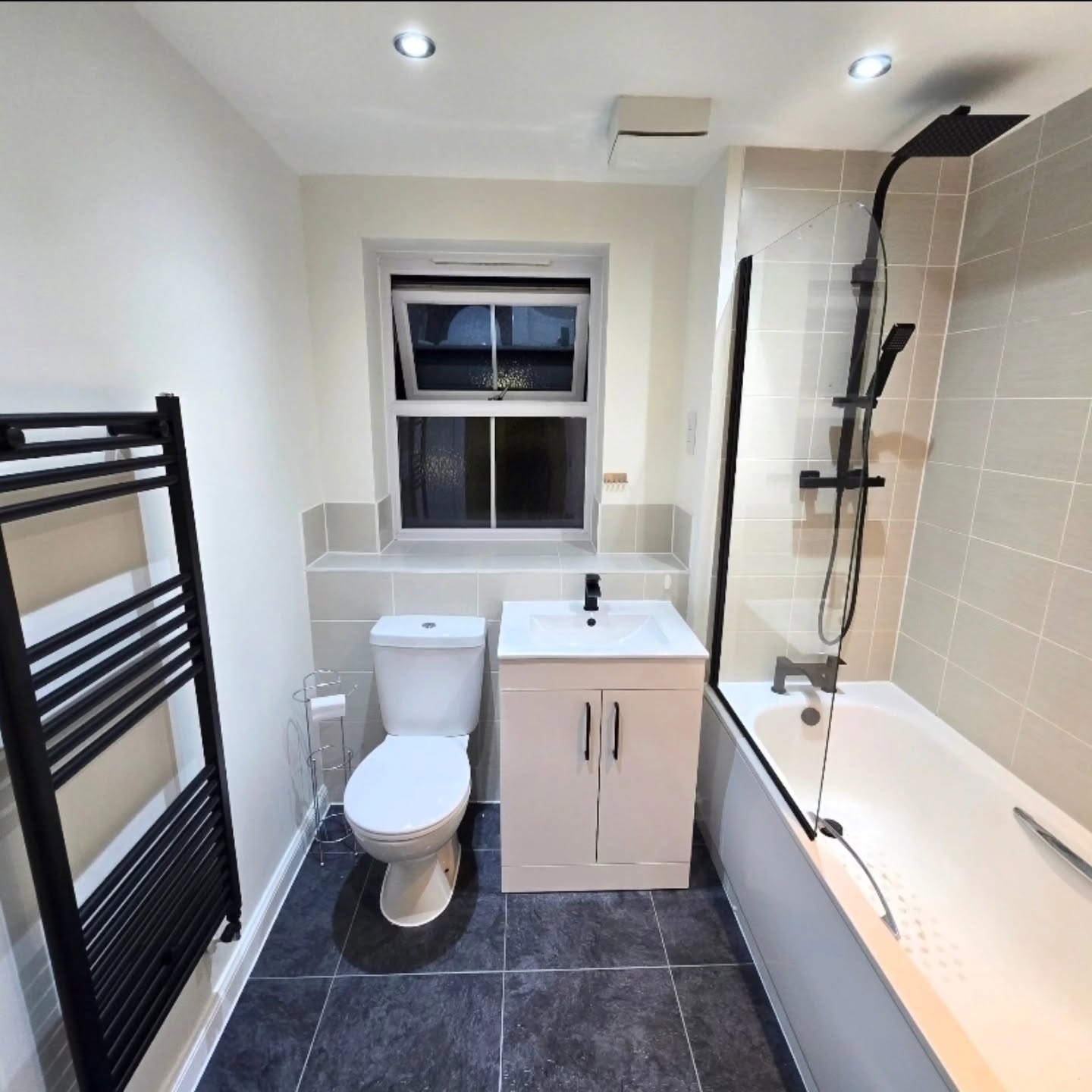 Family bathroom after upgrade with fitted vanity and black fittings